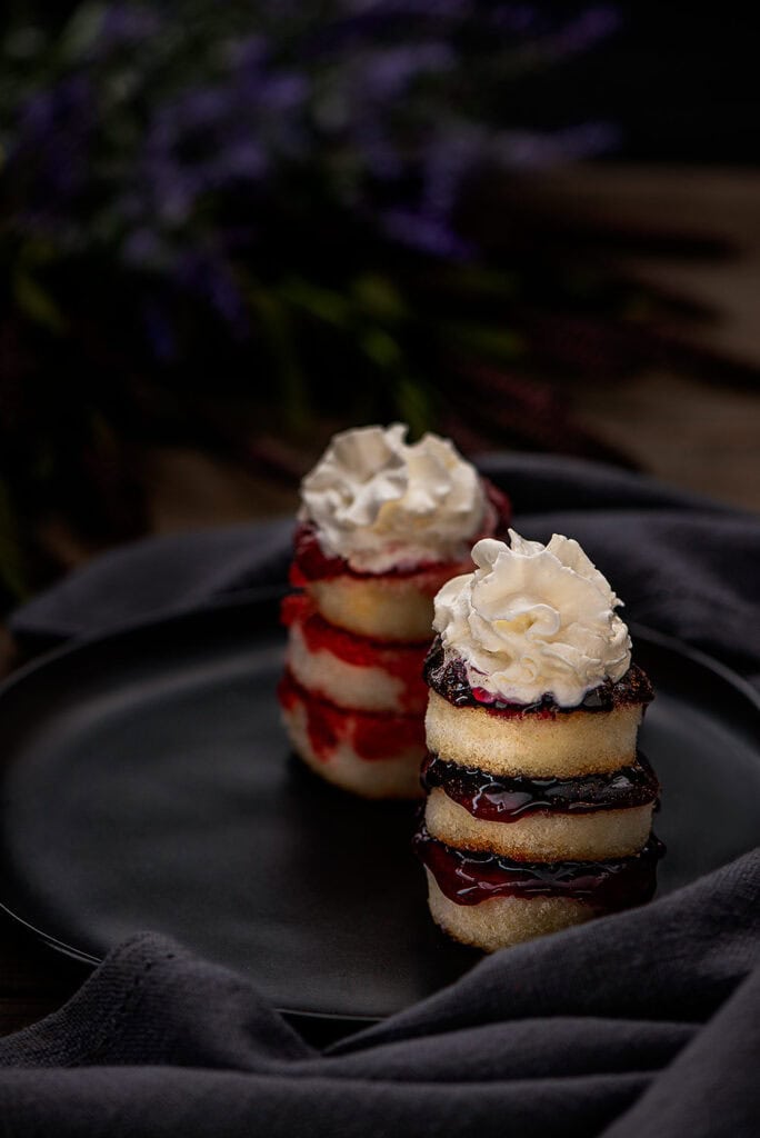 broiled angel food cake on a serving plate topped with Maple Whipped Toppingw-1 small circular angel food cake layered with pie filling