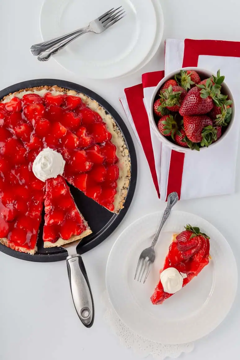 Need to ripen fruit post. Beautifully ripened fruit made into a Strawberry Pizza. There is a round pizza pan filed with our delicious dessert, a bowl of ripped strawberries and a dessert plate with a slice of strawberry pizza topped with our Maple Whipped Topping