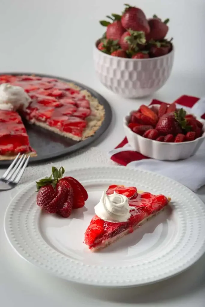 Strawberry Pizza--5 slice of strawberry pizza, serving tray of strawberry pizza, sliced strawberries in a bowl
