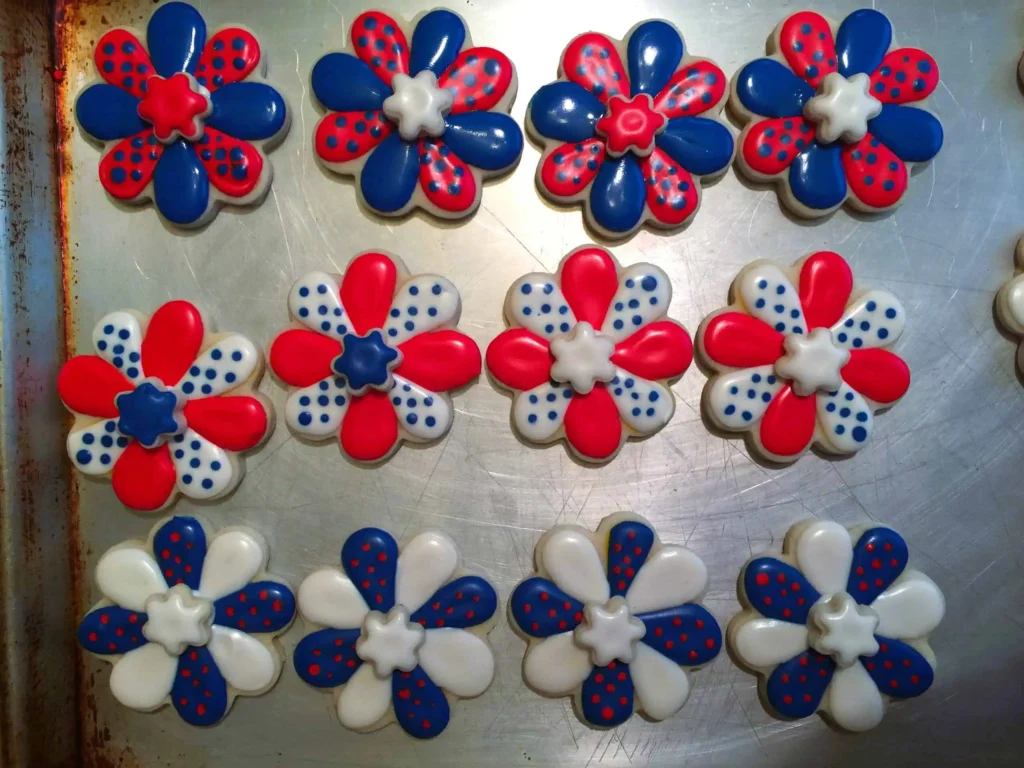 Sugar Cookies and Royal Icing4268-scaled Patriotically decorated sugar cookies with royal icing in the shape of flowers in red, white and blue colors