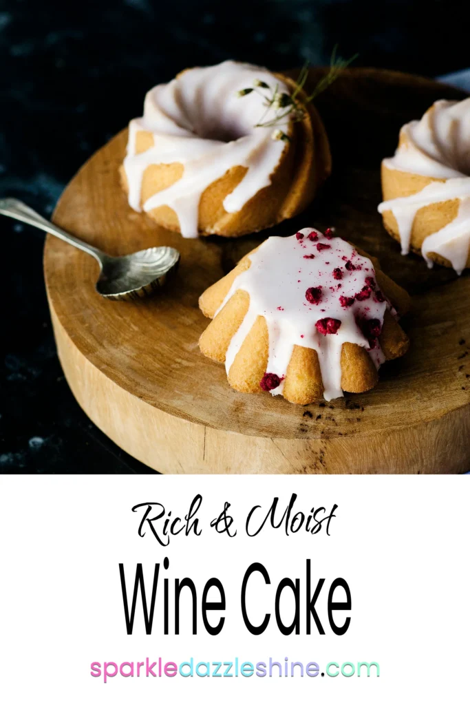 three mini bundt cakes decorated with white frosting, sitting on a wooden chopping board.