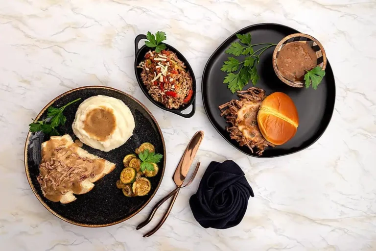 Setting on a marble table are two plates containing Delicious Gravy and more gravy.