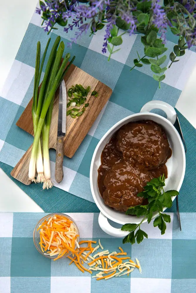 Plate with deliciously prepared Salisbury steak and hashbrown casserole
