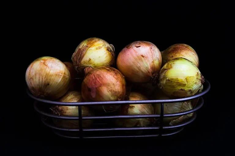 We aren't going to cry over these onions. Ripe unions in a metal kitchen basket