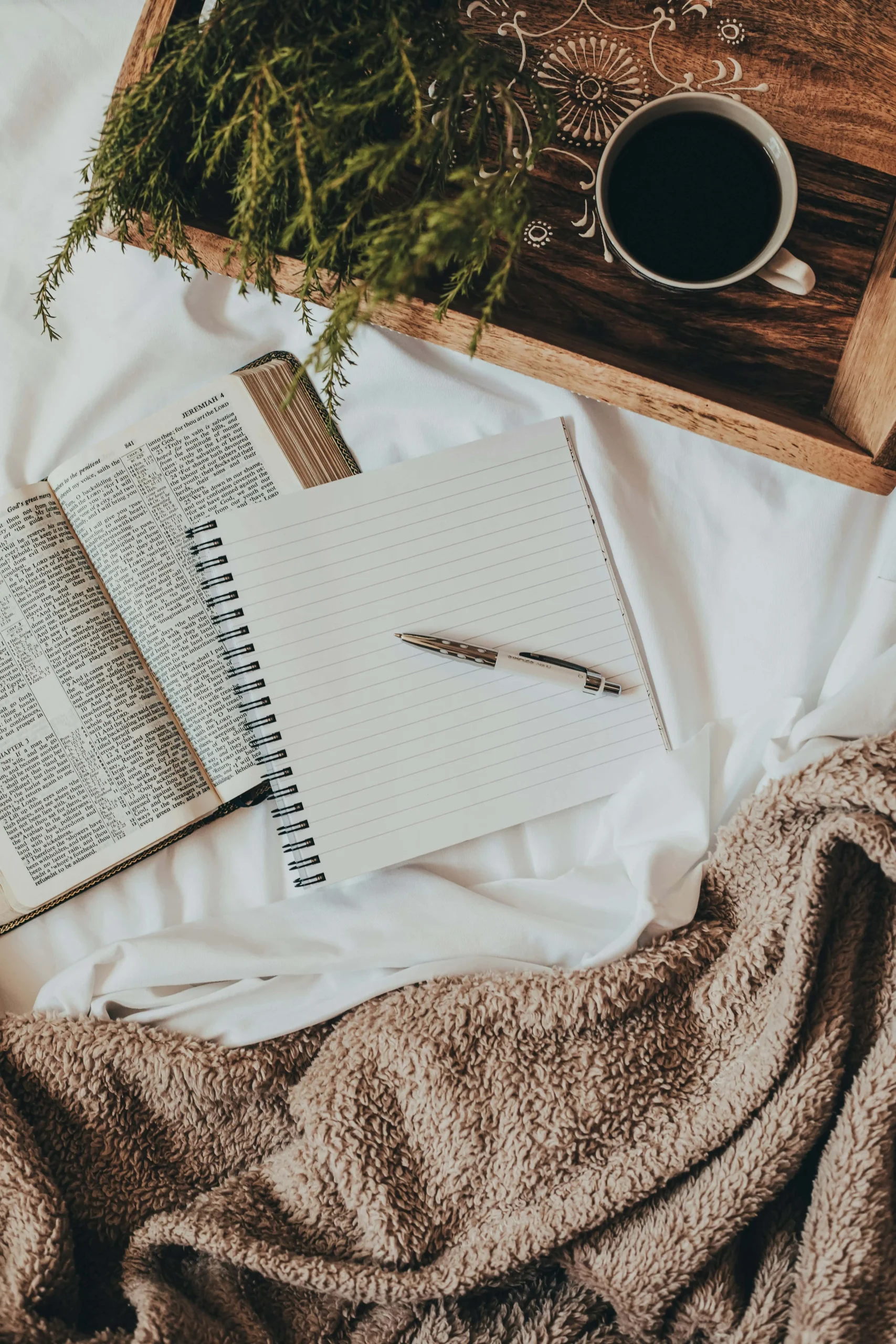 Powerful Daily Journaling Habit blog post. Showing a cozy setting with blankets, journal, pen and tray on a bed