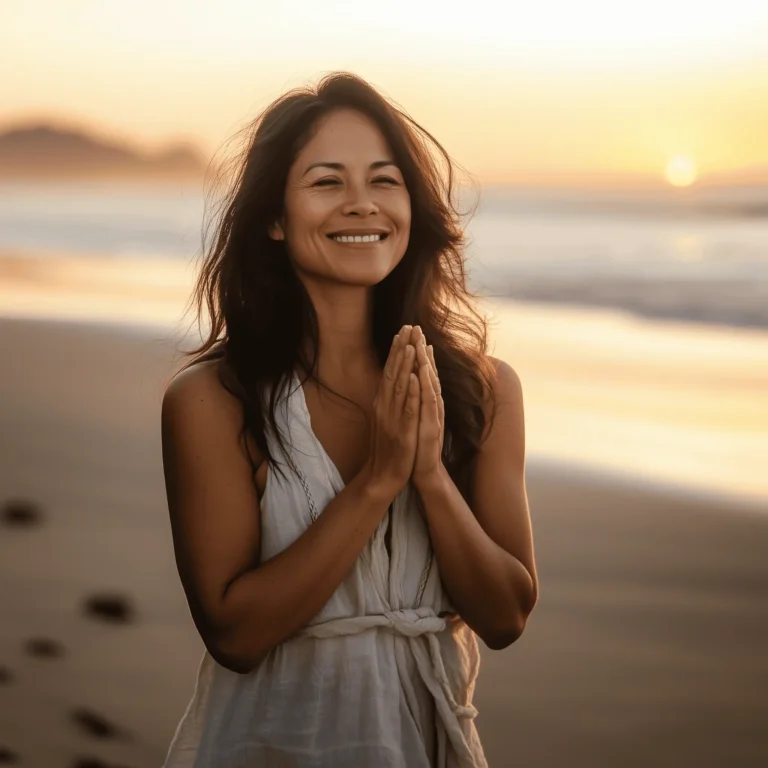 We can all benefit from a little gratitude journey. Gratitude, a smiling woman stands on a beach at sunset with her hands in a prayer gesture, radiating calm and presence. The warm glow of the setting sun enhances the peaceful mood, symbolizing a deep sense of gratitude and connection to the moment.