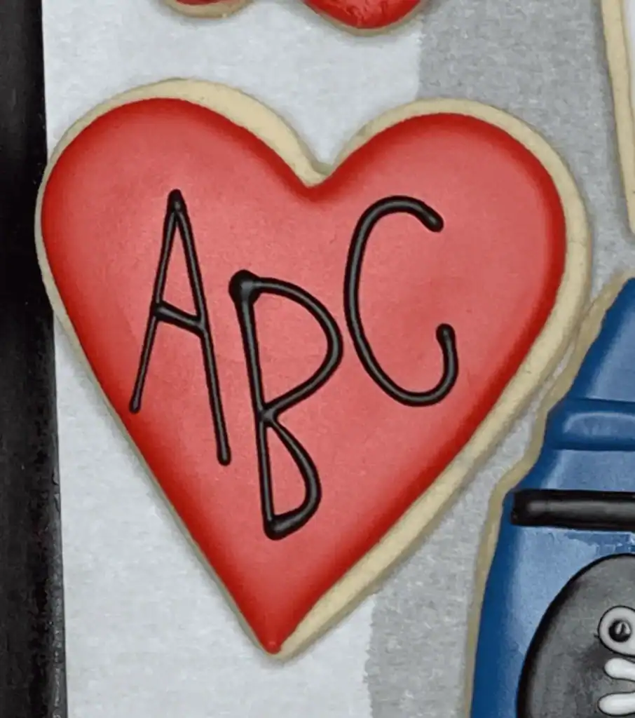 heart shaped sugar cookies with ABC written on them