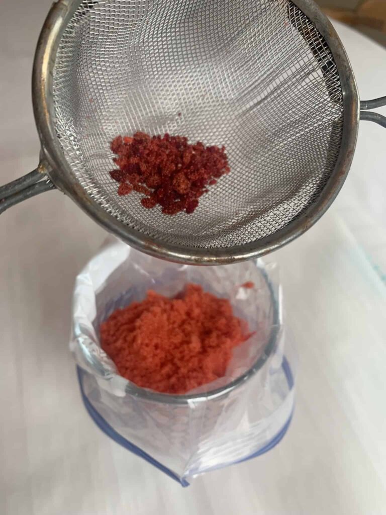 Sifting homemade sanding sugar.