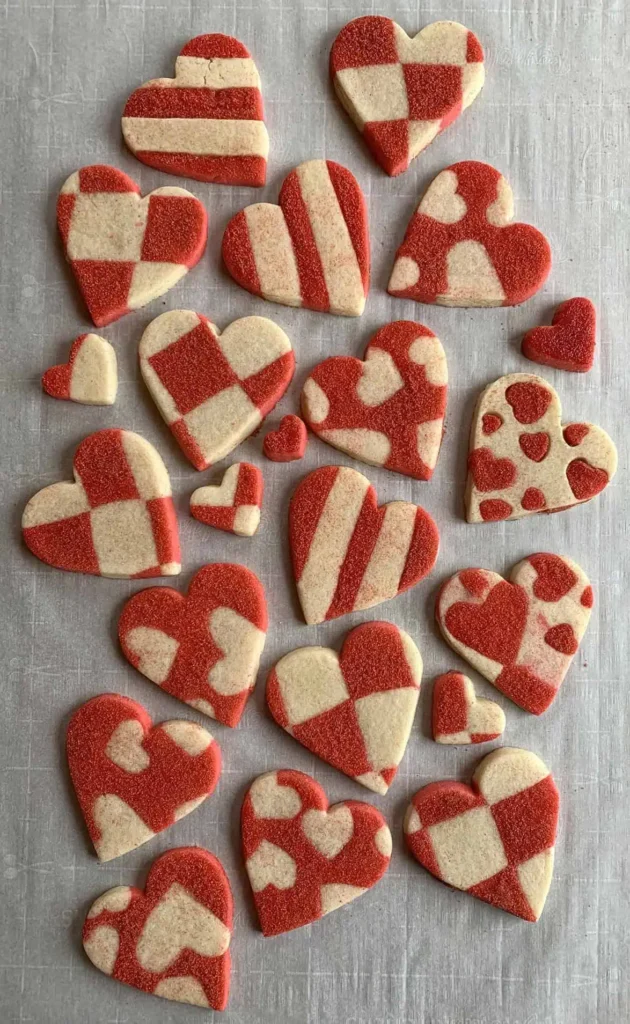 Heart shaped sugar cookies with sanding sugar applied.