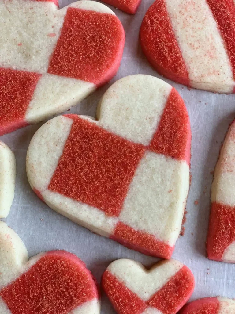 Heart shaped sugar cookies with sanding sugar applied.