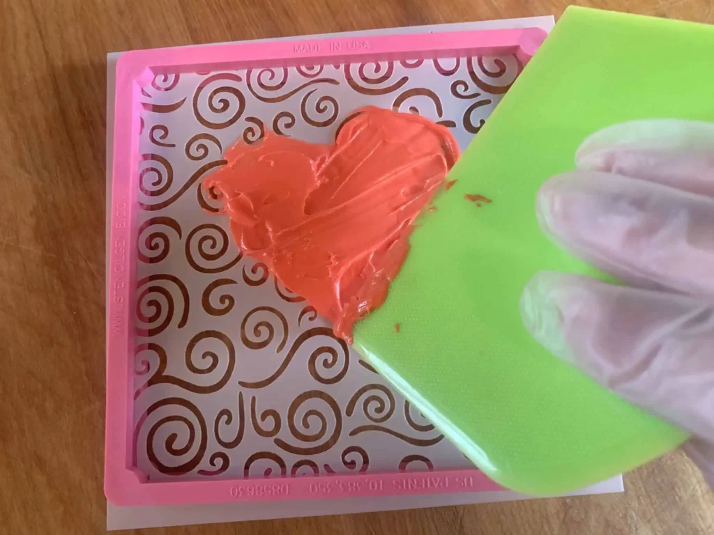 Stenciling tool with stencil and sugar cookie.