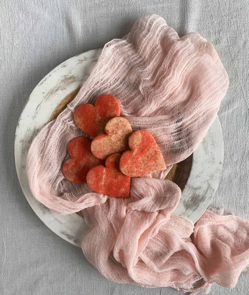 Heart shaped sugar cookies with a marbled dough pattern dusted with sanding sugar.