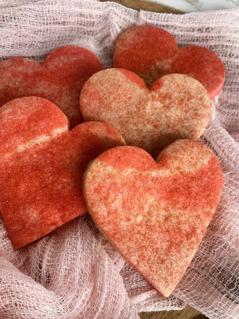 Heart shaped sugar cookies with a marbled dough pattern dusted with sanding sugar.