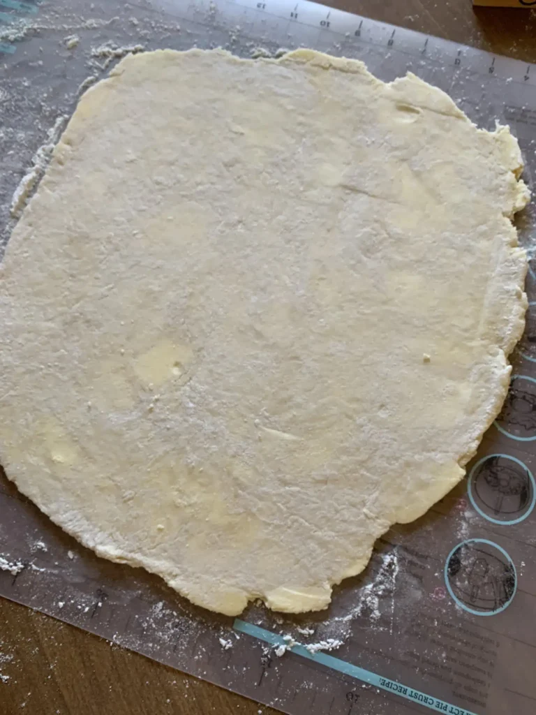 Rolled out best flaky pie dough on a floured work surface.